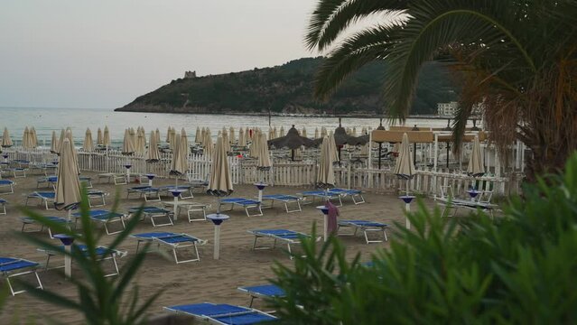 Sun loungers and umbrellas on the beach in Scauri, Italy.