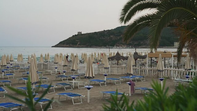 Sun loungers and umbrellas on the beach in Scauri, Italy.