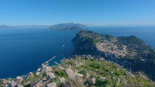 Touristic Town on Capri Island in Bay of Naples, Italy. Sunny Blue Sky. Nature Background. View from top of Mountain. Slow Motion Cinematic Pan
