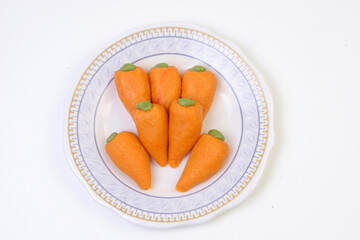 Delicious carrot shape Sweets of India on a plate