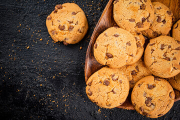 Delicious cookies with pieces of milk chocolate on a plate.