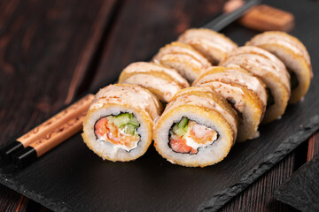 Roll with fish sushi with chopsticks - asian food concept
