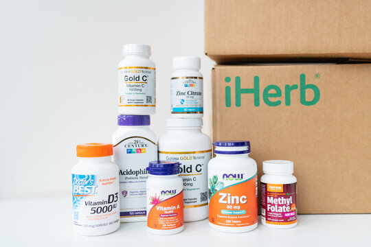 Lviv, Ukraine - December 17, 2022: Unboxing boh delivered from iherb online store. Package with vitamins and supplements to support health.