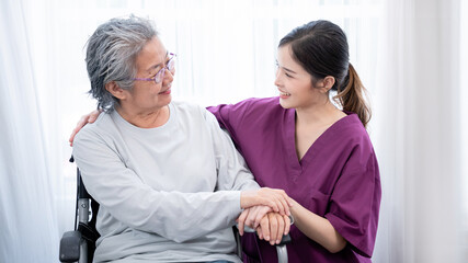 Medical staff taking and caregiver senior woman in Home. Home care concept.