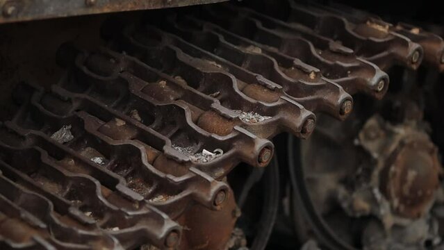 caterpillars of a burned-out Russian tank. Side view of a tank track on a city street in Kyiv, Ukraine. Remains of a burnt and wrecked tank of the Russian army. war in ukraine