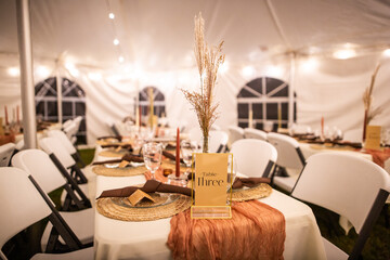 Amazing Out of the box wedding venue tent with dinner equipment on tables and warm fairy string lights