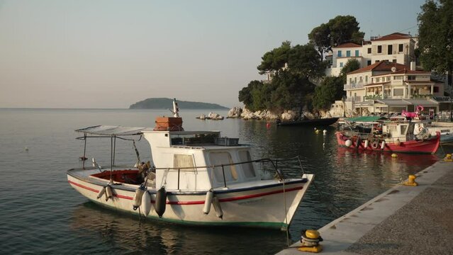 Colourful boats and Old Town at sunrise, Skiathos Town, Skiathos, Sporades Islands, Greek Islands