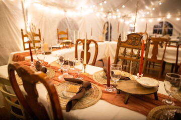 Amazing Out of the box wedding venue tent with dinner equipment on tables and warm fairy string...
