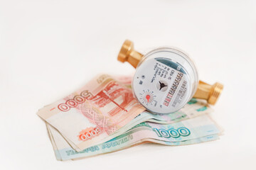 Water meter with Russian banknotes. Payment for utilities and water supply