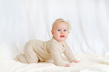 Cute little baby girl with a bow on a white background
