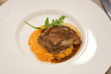 tasty ready-to-eat dish of iberian secreto iberico with sobrasada parmentier and vermouth sauce