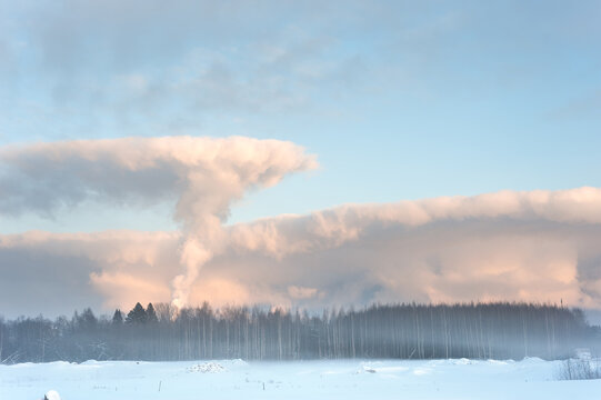 Temperature inversion. On a very cold winter day smoke rising from factory chimneys is stopped by an overlying layer of warmer air.