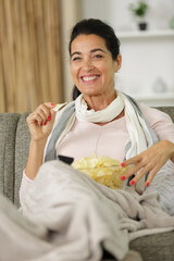 woman with bowl of chips watching tv