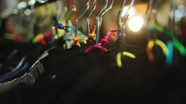Clothes on hangers closeup at handcraft market. High quality 4k footage