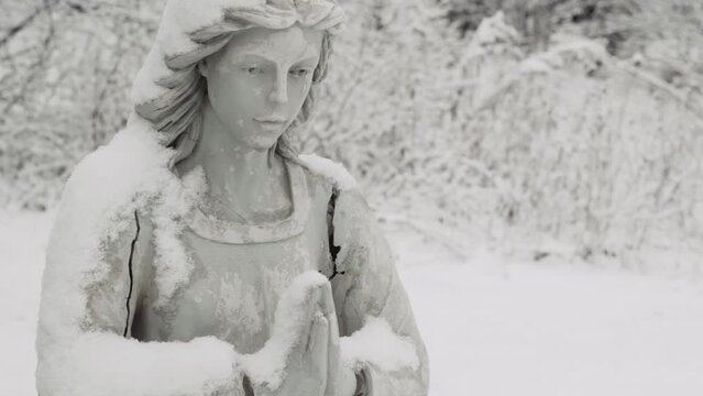 Tight shot of angel statue during Winter