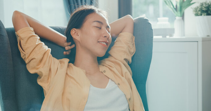 Close-up Youth Asia Female Girl Or University Student Sit On Sofa Chair Take A Rest Relax Feel Chill And Calm After Finish Work In Living Room At House. Environment At Home, Work Life Balance Concept.