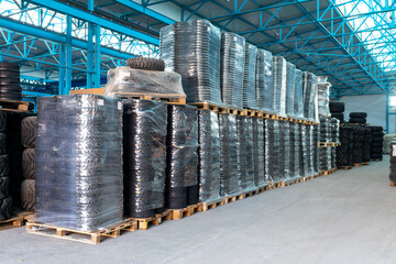 Storage room. warehouse with packed tires for agricultural machinery © LariBat