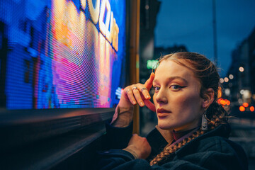 portrait of a woman in a night city in colored light
