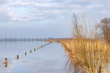 Blocked cycling road caused by flooded river IJssel near Welsum in Overijssel in The Netherlands