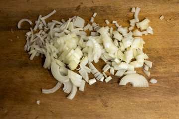 finely chopped onion on a wooden cutting board