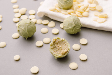 Natural healthy candies with white chocolate. Green cheese truffles. Bitten candy
