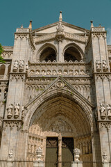 Fototapeta na wymiar Toledo, España. April 29, 2022:Toledo, España. April 29, 2022: Santa Iglesia Catedral Primada de Toledo with beautiful blue sky.