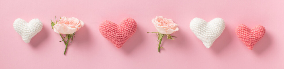 Valentine's Day background. Horizontal banner with roses and hearts on a light pink background.