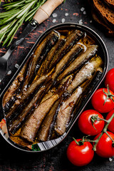 Sprats with cherry tomatoes on the table. 