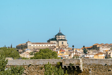Fototapeta na wymiar Toledo, España. April 29, 2022: Tavera Hospital and panoramic landscape with blue sky.