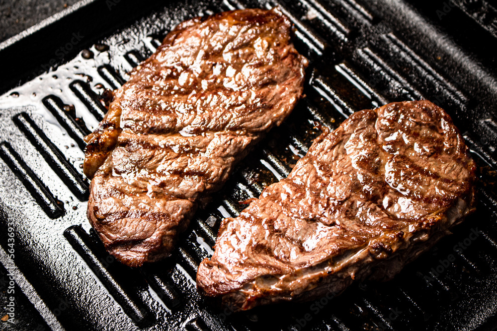 Canvas Prints Delicious grilled steak in a frying pan. 