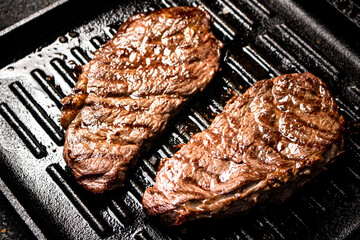 Delicious grilled steak in a frying pan. 