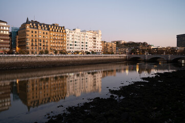 Fototapeta premium Evening walk along river in central part of Donostia or San Sebastian city, Basque Country, Spain