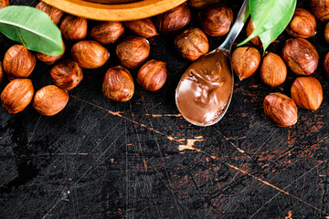 Fototapeta premium Hazelnut butter in a spoon on the table. 