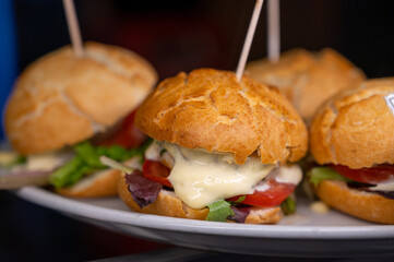 Typical mini burger snack of Basque Country, pinchos or pinxtos, small piece of bread with different toppings, served in bar in San-Sebastian or Bilbao, Spain