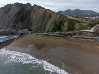 View on sandy beach, rocks and Atlantic ocean in Zumaia touristic ciry, Basque Country, Spain