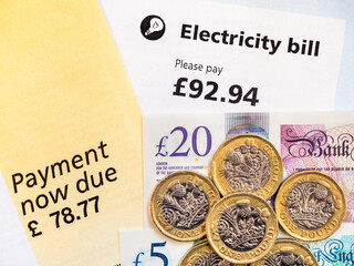 Energy fuel bills, total close-up and pound coins. Concept for price rise, cost of living, electric bills, gas, fuel, economy, heating and inflation