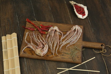 raw squid tentacles with pepper, salt, Japanese sticks on kitchen board ready for cooking closeup photo © ulianna19970