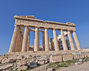 Fototapeta premium Parthenon under clear blue sky, the famous ancient Greek temple on the acropolis of Athens. Cultural travel Greece.