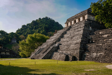 Ancient Mayan temple surrounded by jungle in Palenque 