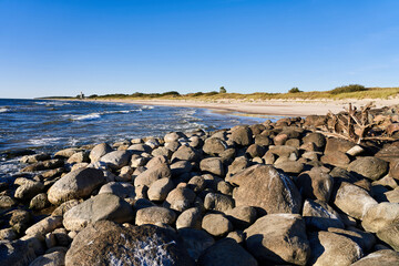 The Baltic Sea in calm weather. Coastline with a breakwater near the town of Nida in Latvia