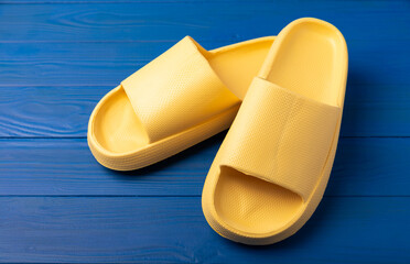 Yellow rubber summer slippers. Replacement shoes for home or office. Yellow slippers on a...