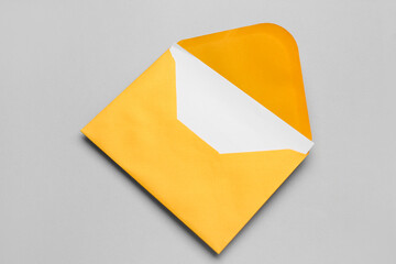 Yellow paper envelope with card on light background