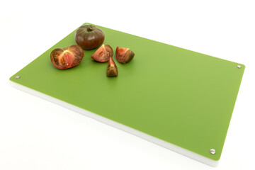 Vegetables on green professional chopper - chopped black tomatoes