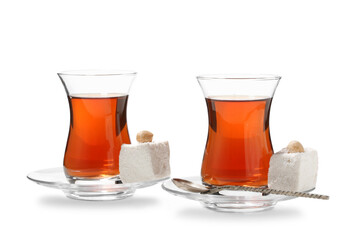 Glass cups of Turkish tea and sweets on white background