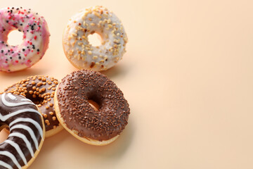 Different glazed donuts on color background