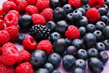 Heap of fresh ripe berries on color background, closeup