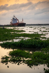 Chemical tanker docked in the Magdalena River at sunset. Colombia.