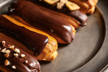 Plate of chocolate eclairs, closeup