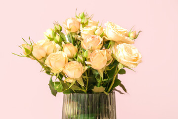 Vase with beautiful rose flowers on pink background, closeup