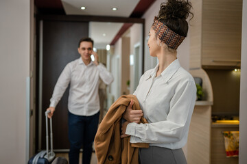 Fototapeta premium Couple woman and man wife husband enter hotel or motel room apartment